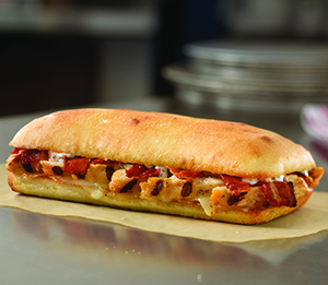 Chicken Bacon Ranch Sandwich - Enjoy our flavorful grilled chicken breast topped with smoked bacon, creamy ranch and provolone cheese on artisan bread baked to golden brown perfection.