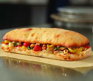 Mediterranean Veggie Sandwich - Roasted red peppers, banana peppers, diced tomatoes, fresh baby spinach, fresh onions, feta, provolone and American cheese. On artisan bread and baked to a golden brown.